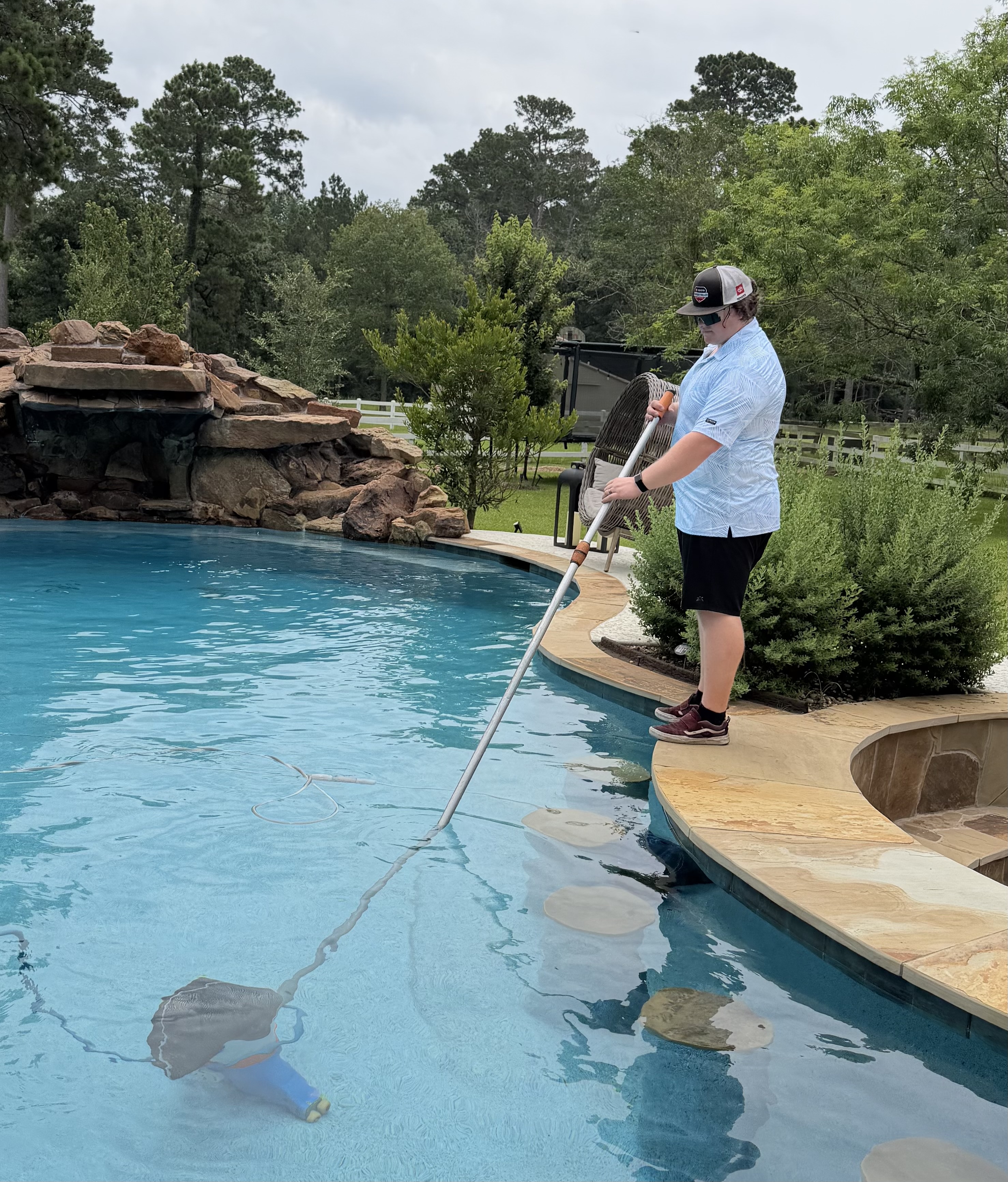 Professional pool cleaning in progress